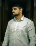 A man with a beard standing in a hallway